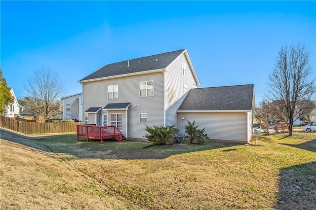 rear view of property featuring a wooden deck and a yard