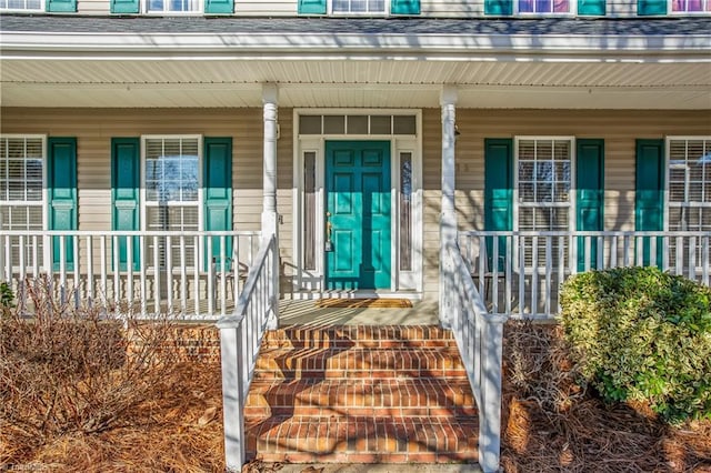 view of exterior entry with covered porch