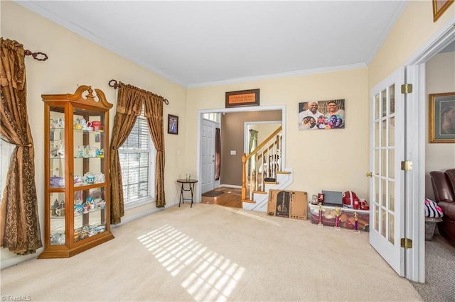 living area with crown molding, light carpet, and french doors