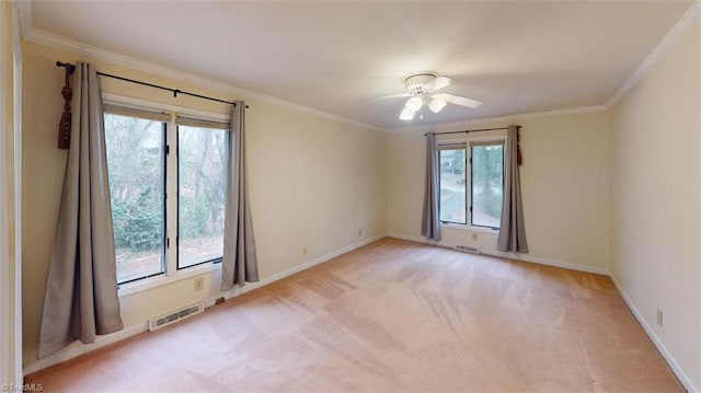 spare room featuring light carpet, ceiling fan, and ornamental molding