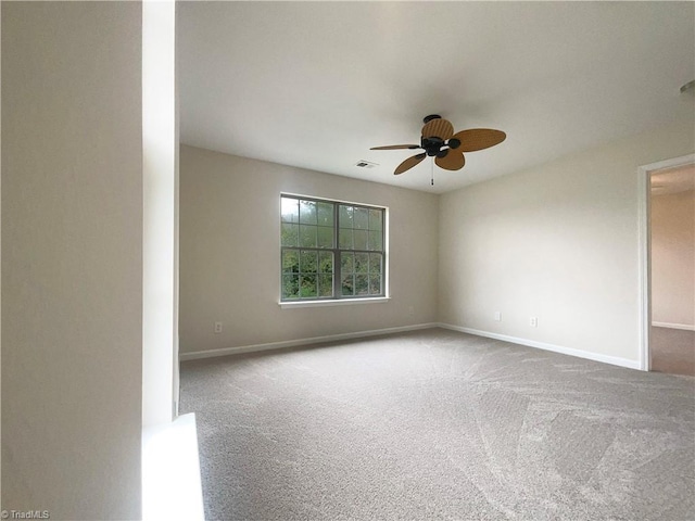 carpeted spare room with ceiling fan