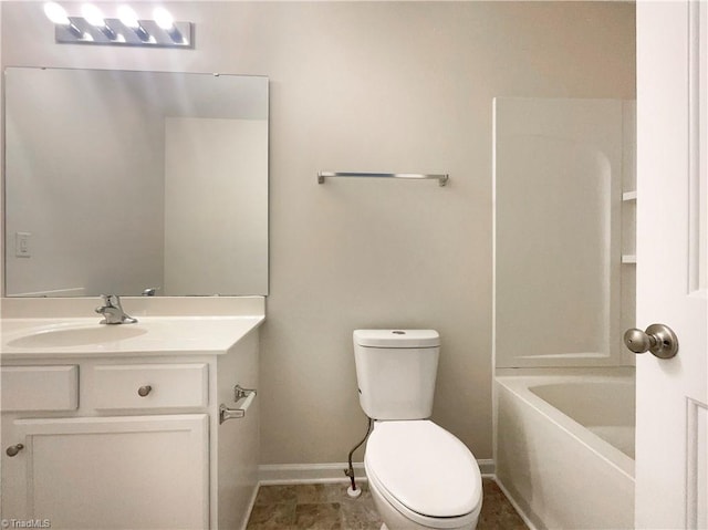 bathroom featuring a bathtub, vanity, toilet, and tile patterned floors