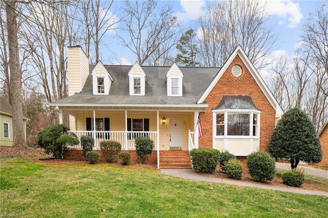 cape cod-style house with a porch and a front lawn