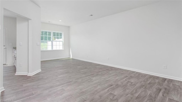 spare room with light hardwood / wood-style floors