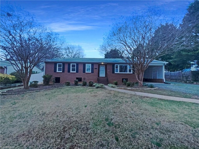 ranch-style home featuring a chimney, fence, a front lawn, and brick siding