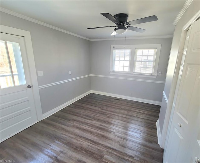 unfurnished room featuring a ceiling fan, dark wood-style flooring, crown molding, and baseboards