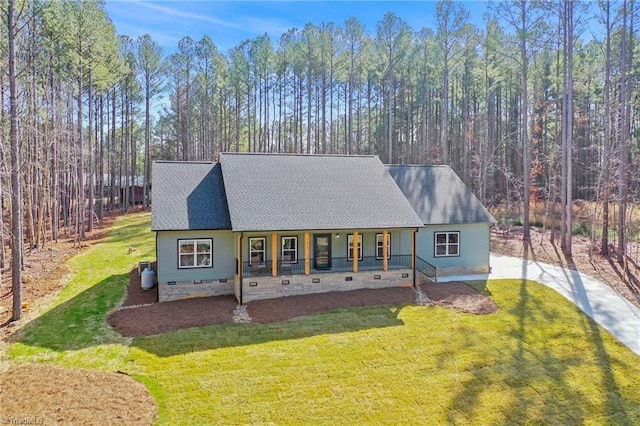 view of front of house with a shingled roof, crawl space, covered porch, and a front lawn