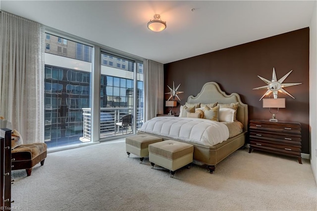 carpeted bedroom with a wall of windows