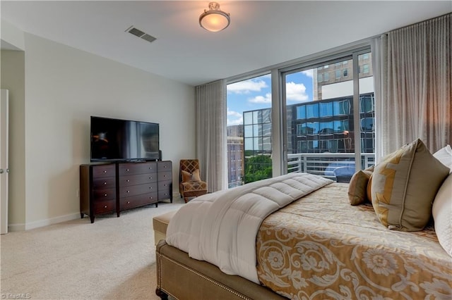 carpeted bedroom with baseboards, access to outside, and visible vents