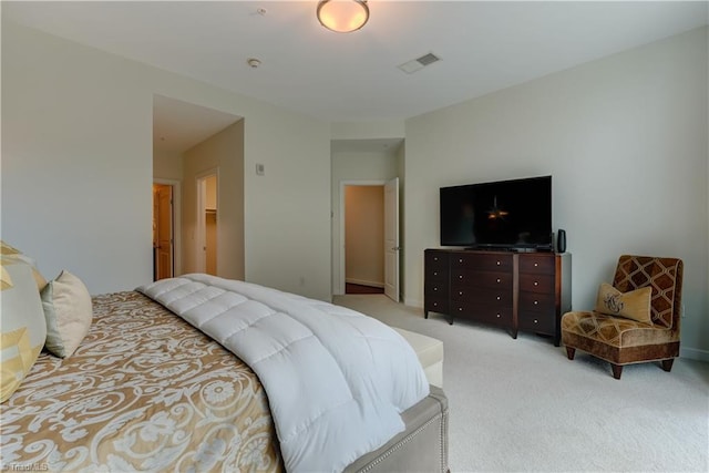 bedroom featuring baseboards, visible vents, and light colored carpet