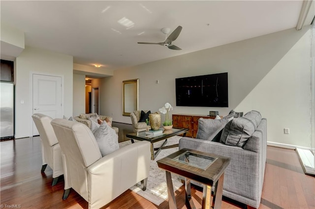 living room with a ceiling fan and wood finished floors