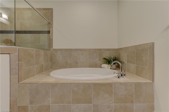 bathroom featuring a tile shower and a bath