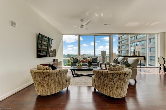 living room with wood-type flooring, visible vents, a wealth of natural light, and expansive windows