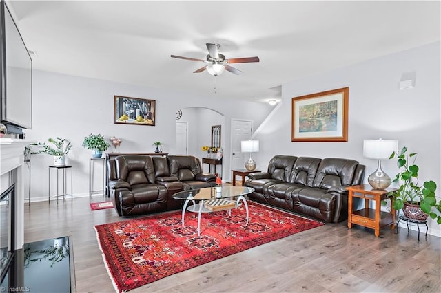 living room with hardwood / wood-style flooring and ceiling fan