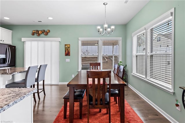 dining room featuring dark wood-type flooring and a chandelier