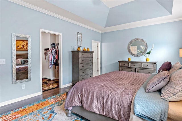 bedroom featuring dark wood-type flooring, a walk in closet, and a closet