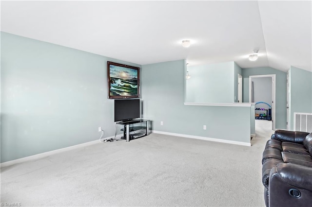 living room with light colored carpet and vaulted ceiling