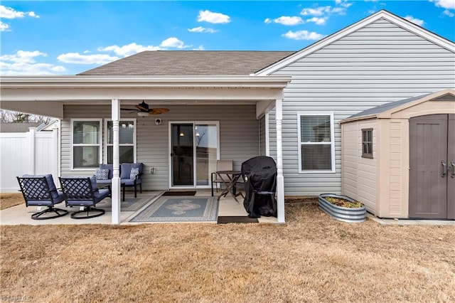 rear view of house with a patio, a yard, ceiling fan, and a shed