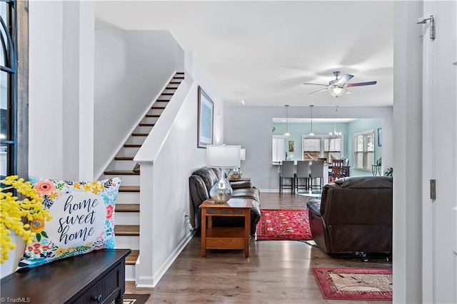 living room featuring hardwood / wood-style flooring and ceiling fan