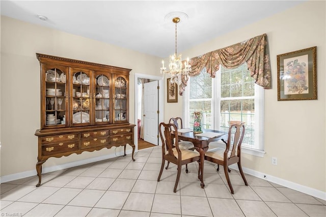 dining area featuring plenty of natural light, baseboards, light tile patterned floors, and a chandelier