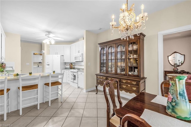 dining space featuring light tile patterned floors and ceiling fan with notable chandelier