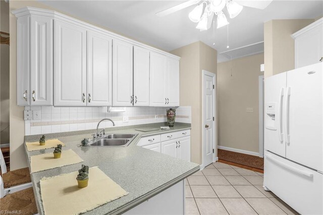 kitchen featuring a sink, white cabinetry, and white fridge with ice dispenser