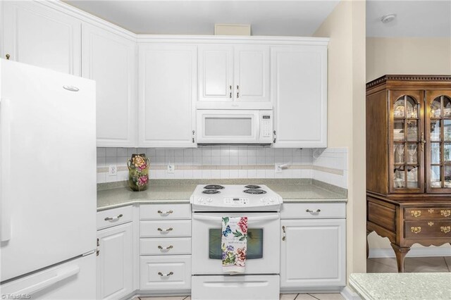 kitchen with decorative backsplash, white appliances, white cabinetry, and light countertops