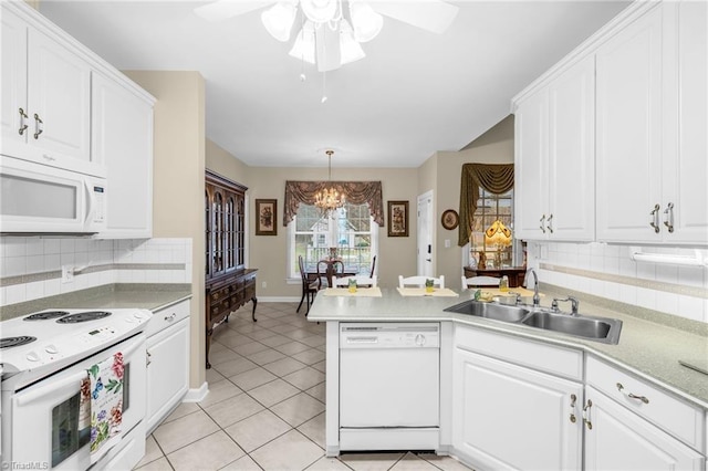 kitchen featuring a sink, white appliances, a peninsula, white cabinets, and light tile patterned floors