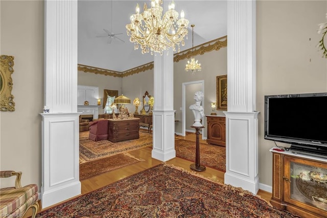 bathroom with an inviting chandelier, a high ceiling, decorative columns, and wood finished floors