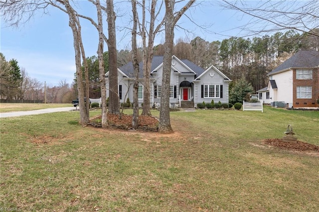 view of front of house featuring central air condition unit and a front yard