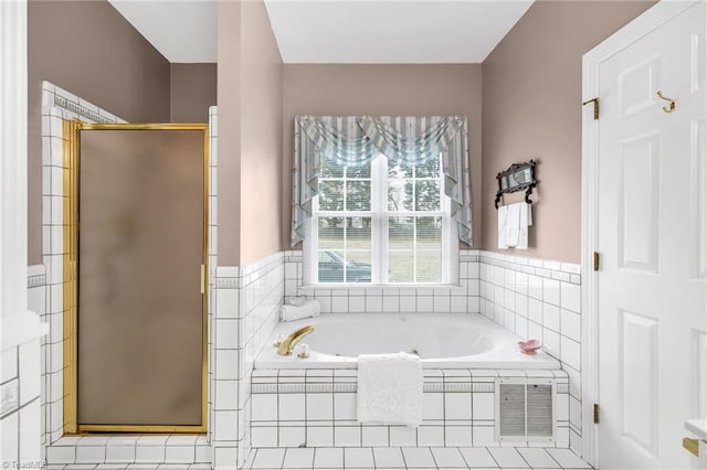 bathroom with a bath, visible vents, and a stall shower