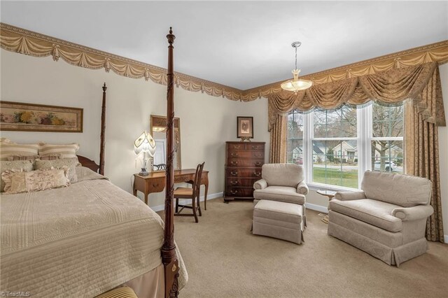 bedroom featuring baseboards and light carpet