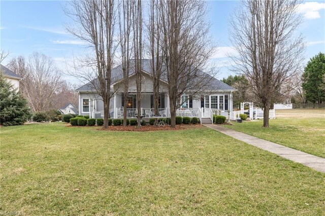 single story home featuring covered porch and a front lawn