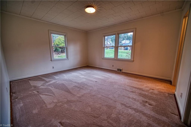 unfurnished room featuring light carpet, baseboards, and ornamental molding