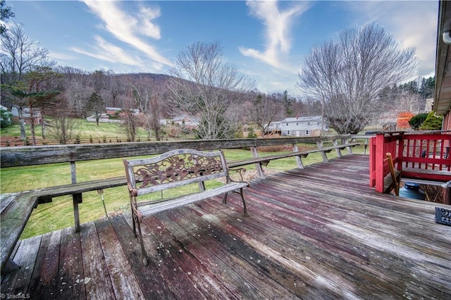 wooden terrace with a yard and a mountain view