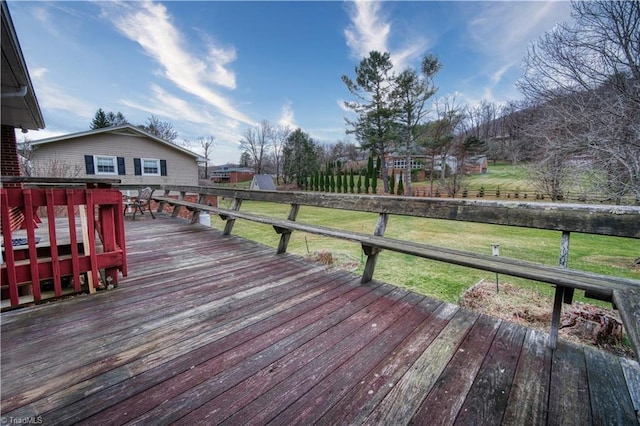 wooden deck featuring a yard