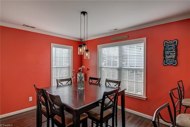 dining space featuring ornamental molding and dark hardwood / wood-style floors