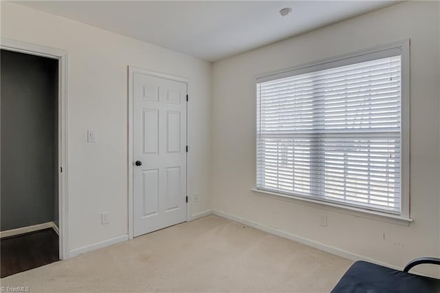 unfurnished room featuring light carpet