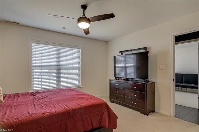 bedroom featuring ceiling fan and light carpet