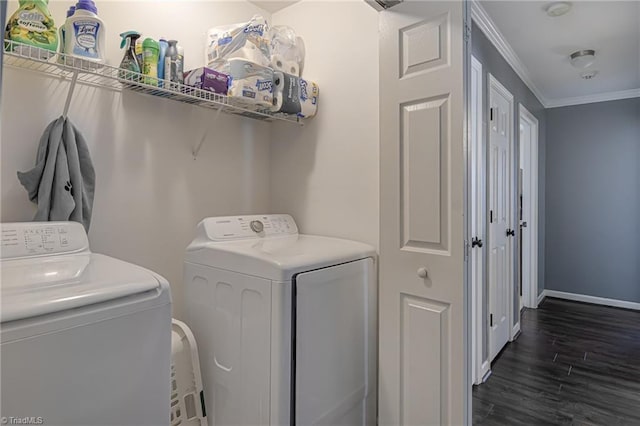 washroom featuring washer and dryer, crown molding, and dark wood-type flooring