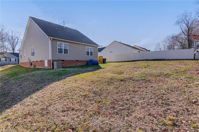 rear view of house featuring a yard and central air condition unit