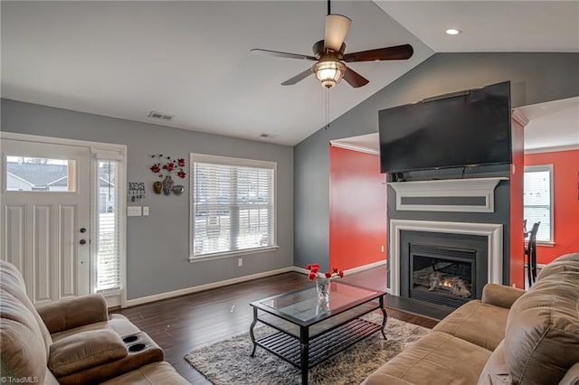 living room with dark hardwood / wood-style flooring, ceiling fan, and vaulted ceiling