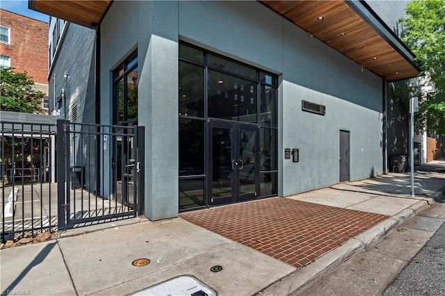 400 W 4th St Unit 305, Winston-Salem, NC 27101 - property entrance with french doors, stucco siding, and fence