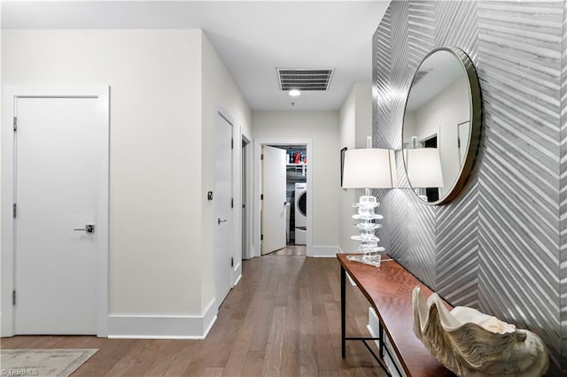 400 W 4th St Unit 305, Winston-Salem, NC 27101 - hallway with washer / dryer, baseboards, wood finished floors, and an accent wall