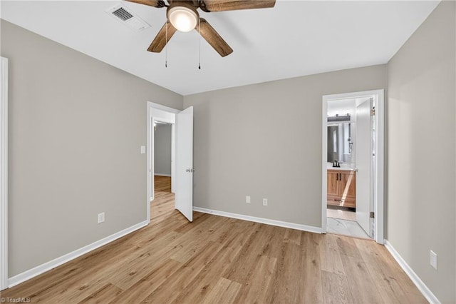 1814 Guyer St Unit A, High Point, NC 27265 - unfurnished bedroom with light wood finished floors, baseboards, ceiling fan, and connected bathroom
