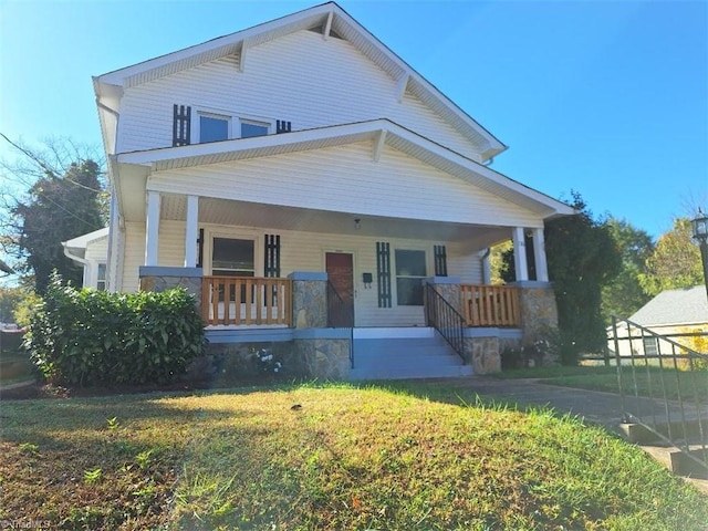 view of front of home with a front yard and covered porch