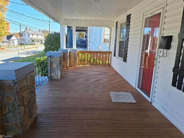 wooden terrace featuring covered porch