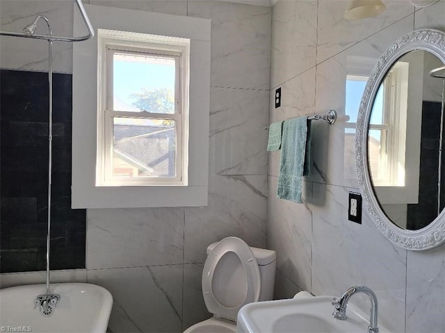 full bathroom featuring toilet, shower with separate bathtub, sink, and tile walls