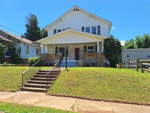 view of front facade featuring a front lawn and covered porch