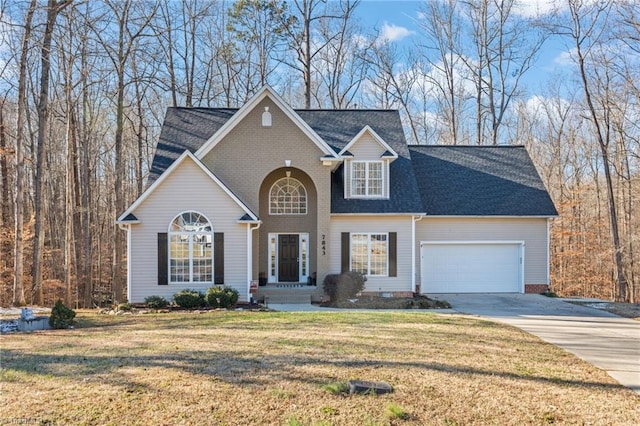 view of front of property with a garage and a front lawn